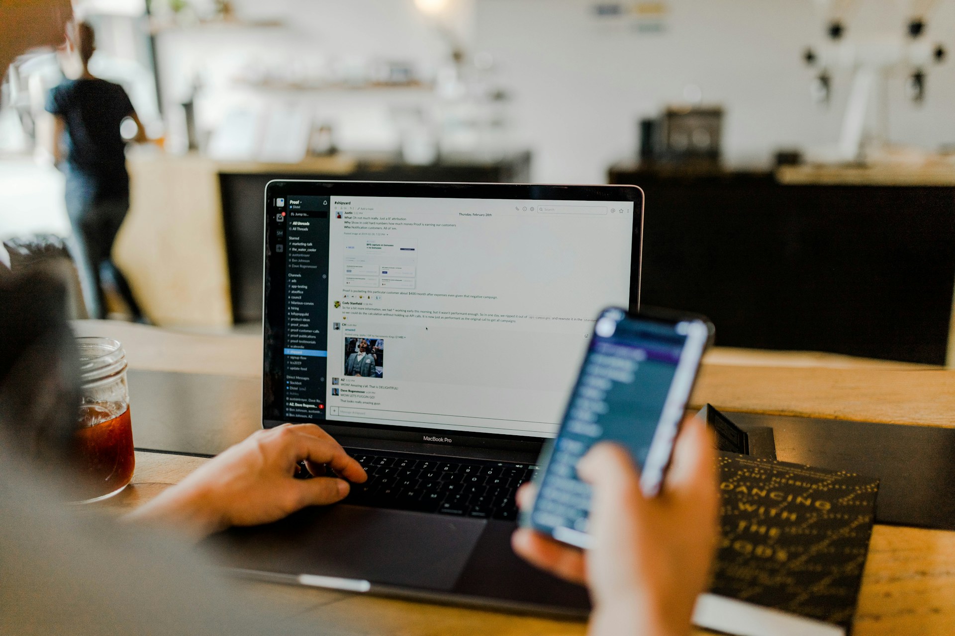 Person working on a laptop and smartphone with cloud apps